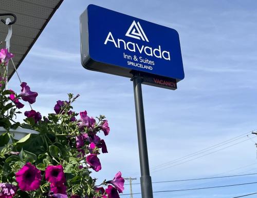 aania sign on a pole next to some flowers at Anavada Inn & Suites - Prince George in Prince George