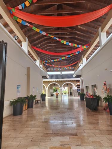 an empty hallway with flags hanging from a ceiling at SOL CARIBE BEACH in Punta Cana