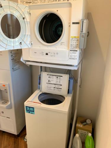 a laundry room with a washer and a dryer at Mt. Fuji Glamping MOONLIGHT VILLA Kawaguchik in Fujikawaguchiko