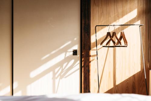 a pair of hangers on a wall next to a door at Nipponia 甲佐 疏水の郷 in Kosa