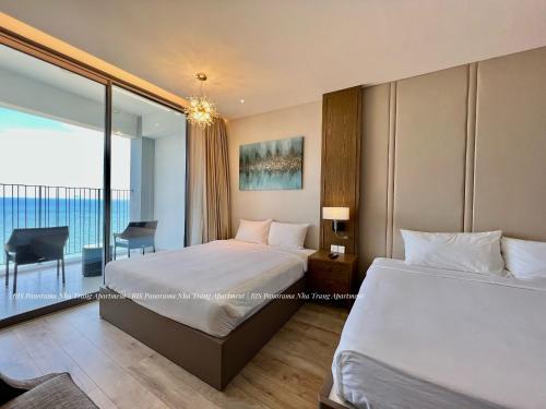 a bedroom with two beds and a view of the ocean at Panorama Nha Trang Inn in Nha Trang
