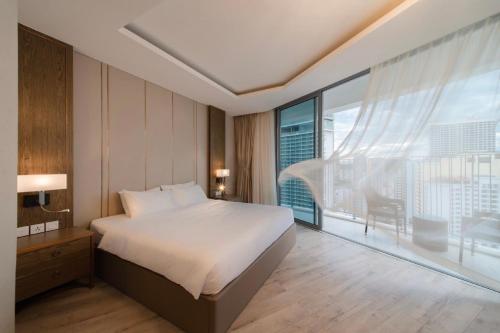 a hotel room with a bed and a large window at Panorama Nha Trang Inn in Nha Trang