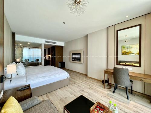a bedroom with a bed and a desk and a couch at Panorama Nha Trang Inn in Nha Trang