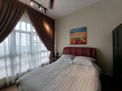 a bedroom with a bed and a painting on the wall at SYG 6 D’Aira Suite Putrajaya 2 Bilik Tidur in Putrajaya
