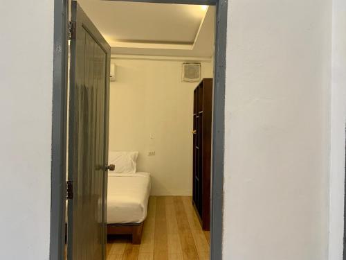 an open door to a bedroom with a bed at La nuit de laos in Luang Prabang