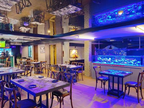 a restaurant with tables and chairs and a bar at GM Hotel and Apartment in Hai Phong