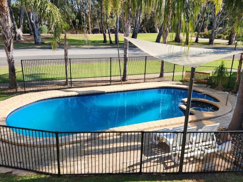 a swimming pool with a fence around it at Barham Bridge Motor Inn in Barham