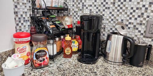 a counter with a bunch of condiments on it at Luxe 3BR Apartment at MIT Harvard with FREE parking in Cambridge