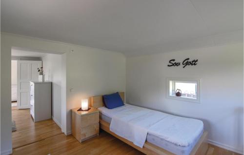 a bedroom with a bed and a sign on the wall at 5 Bedroom Amazing Home In Bjrketorp in Björketorp