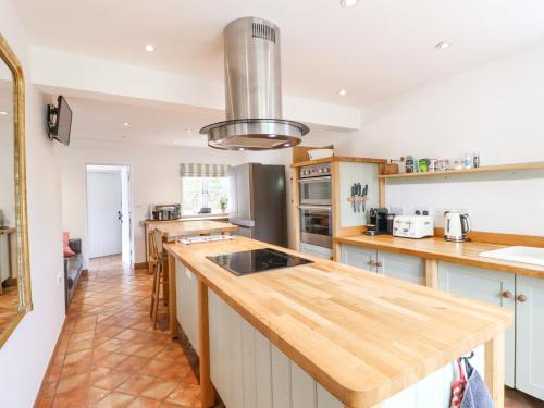 a kitchen with a wooden counter top in a room at Highfield House in Leek