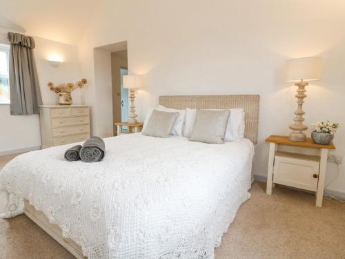 a bedroom with a white bed and a mirror at Highfield House in Leek