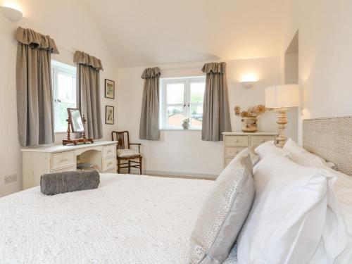 a bedroom with a bed and a desk and a window at Highfield House in Leek