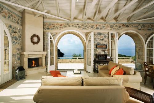 a living room with a couch and a fireplace at Katikies Manis in Kardamili