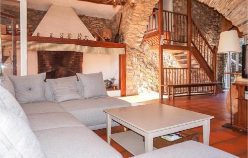 a living room with a couch and a table at 2 Bedroom Amazing Home In Olargues in Olargues