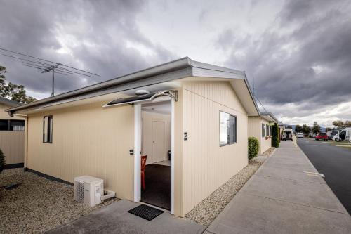 a building with the door open on a street at BIG4 Hobart Airport Tourist Park in Cambridge