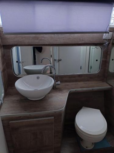 a bathroom with a sink and a toilet and a mirror at BED&BOAT II boatandholiday com in Fano