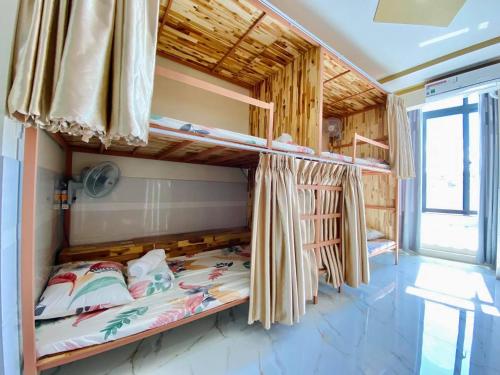 a room with two bunk beds and a window at T'H Homestay in Mui Ne