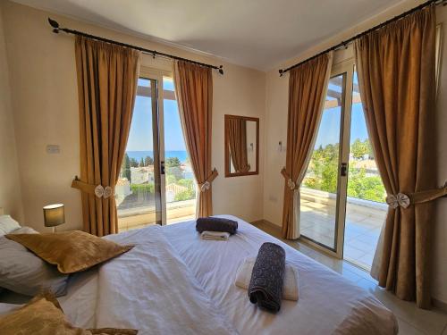 a bedroom with two beds and a large window at Villa Felix in Coral Bay