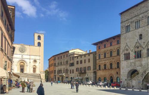 a group of people walking on a city street with a church at Lorenzo in Acqualoreto
