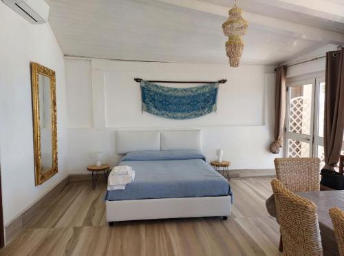 a bedroom with a bed and a table and chairs at Ianira - Le due Lune in Lampedusa