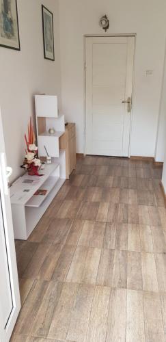 a room with a wooden floor and a white door at Sîrbu Orsova in Orşova