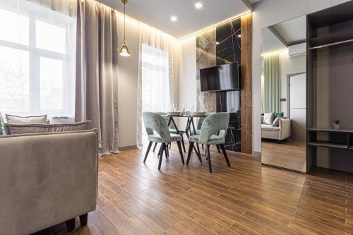 a living room with a dining room table and chairs at Central Family Boutique Apartments 3 in Lviv