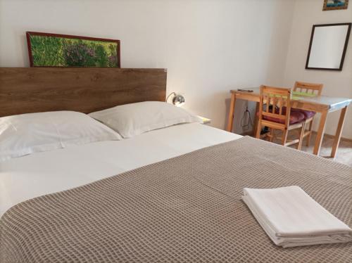 a bedroom with a bed with a table and a chair at B&B Guest House "Be Happy"-parking,breakfast Center in Split