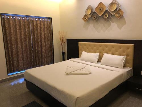 a bedroom with a bed with two napkins on it at Amazing Fun World By Nexottel in Dwarka