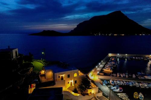 a view of a marina at night with a mountain at Pelagos Seafront Accommodation - Maria in Myrties
