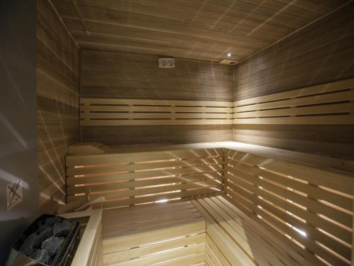 a sauna with wooden walls and a wooden floor at Parkhotel Delta, Wellbeing Resort in Ascona