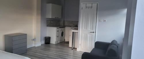 a room with a kitchen and a living room at Garden Room in Northolt