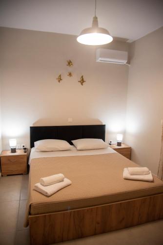 a bedroom with a bed with two towels on it at Mariangelas House in Kos