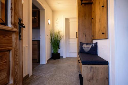 a hallway with a wooden door with a bench at Hof Hintererb in Kitzbühel
