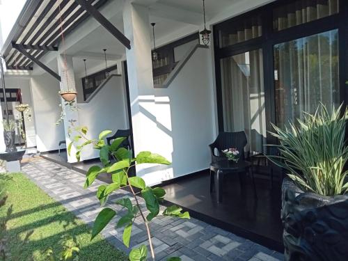 a front door of a house with plants at Airport Faith Hotel in Katunayake