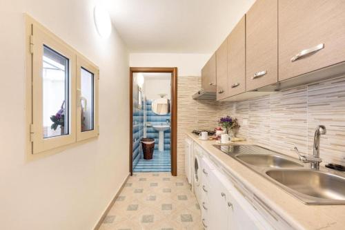 a kitchen with a sink and a counter top at La Casa di Anna in Sava