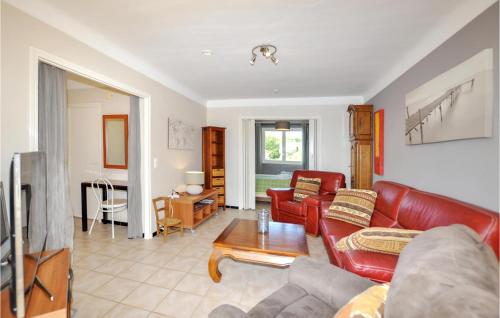 a living room with a couch and a table at Beautiful Home In Saint-André in Saint-André