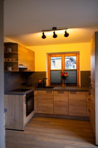 a kitchen with yellow walls and wooden cabinets at Hof Hintererb in Kitzbühel