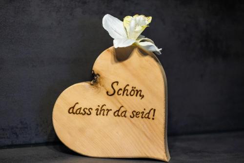 a wooden heart with a sign that reads station class fire dad said at Hof Hintererb in Kitzbühel