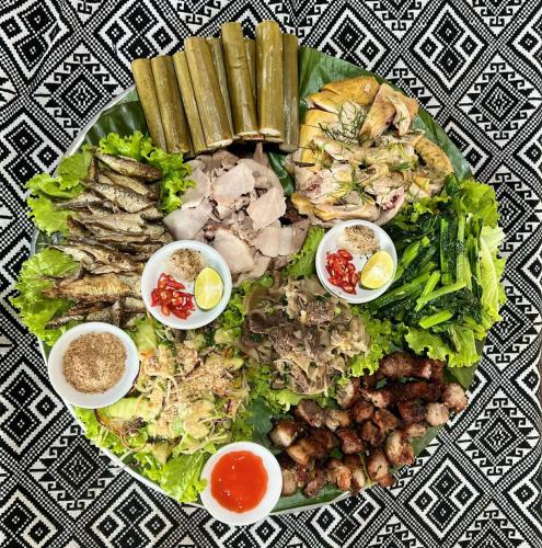 a plate of food with a salad and other foods at Thao Ly Homestay Mai Chau in Hòa Bình
