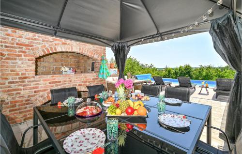 a table with fruits and vegetables on a patio at Lovely Home In Kapela in Kapela