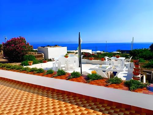 a model of a building with the ocean in the background at Dammuso Pantelleria - Fiori D'Ossidiana in Pantelleria