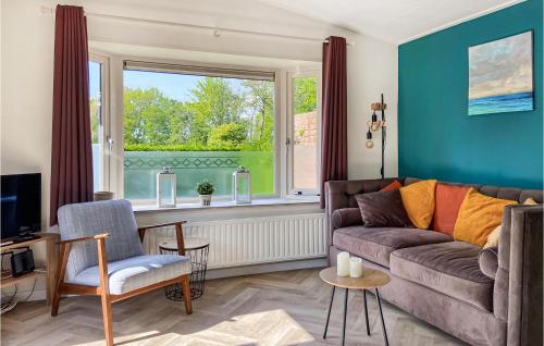 a living room with a couch and a window at Gorgeous Home In Heinkenszand With Wifi in Heinkensand
