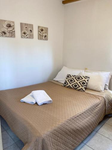 a bedroom with a bed with two towels on it at La casa de campo in Heraklio