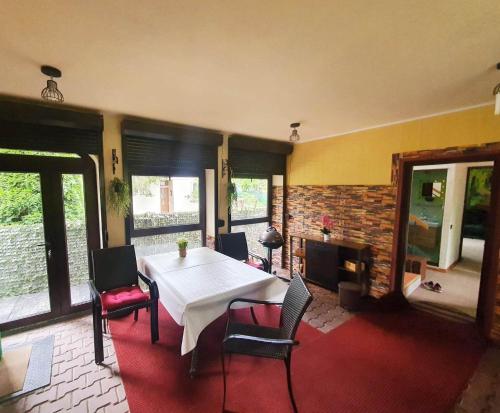 a dining room with a white table and chairs at Magic Home in Slănic