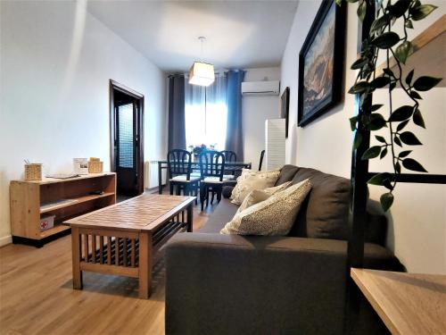 a living room with a couch and a table at Casa Cervantes Toledo in Toledo