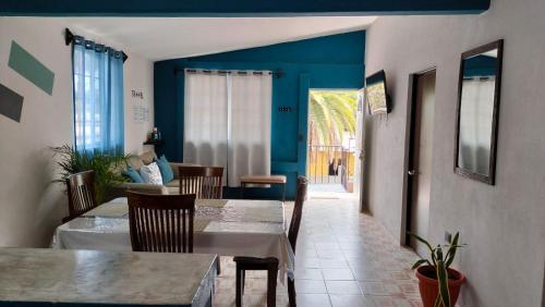 comedor con mesa, sillas y paredes azules en Casas centro Loreto, en Loreto