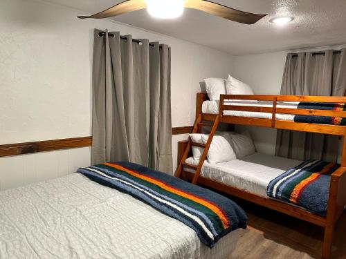 a bedroom with two bunk beds and a window at Three Pines Cabins in Big Bear Lake