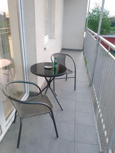 a balcony with a table and two chairs on it at Apartament Jagielloński in Wschowa