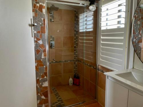 eine Dusche mit Glastür im Bad in der Unterkunft JC COTTAGE in Harden