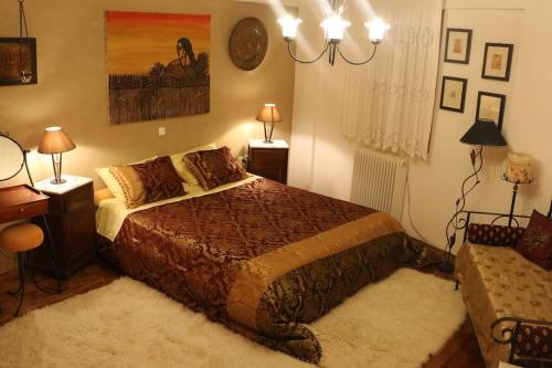 a bedroom with a bed and a desk and a couch at ZenTerra Country house with prive swimming pool and view in Matésion